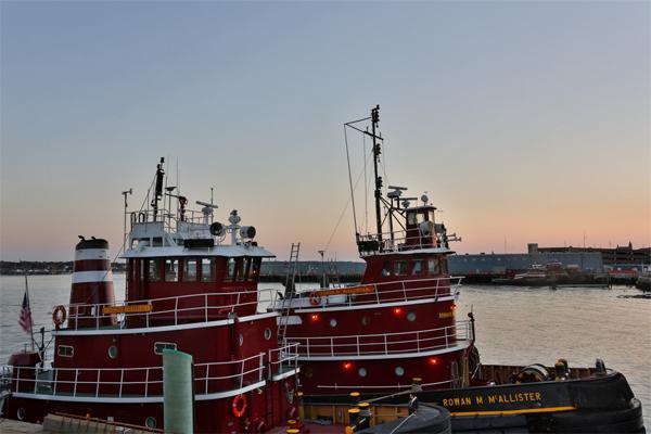 tugs and sunset